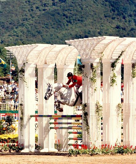 photo of Greg Best on Gem Twist jumping over a huge fence at the 1988 Olympics